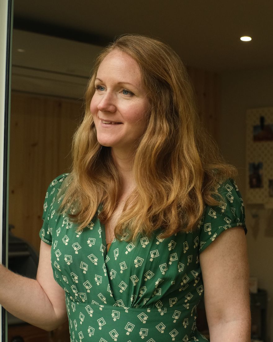 Charlotte smiling in the doorway of her counselling room
